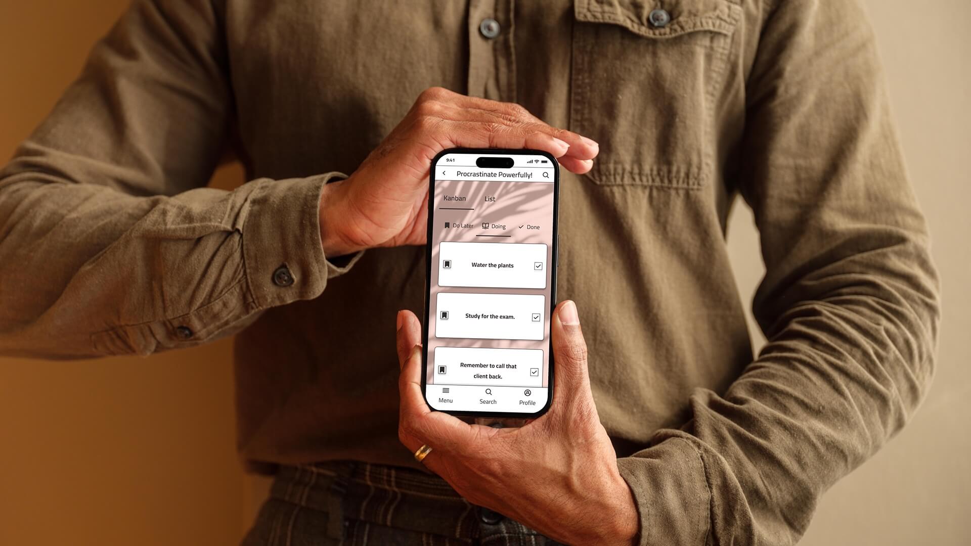Person holding a smartphone with the ProcrastiGreat to-do list app in pastel pink